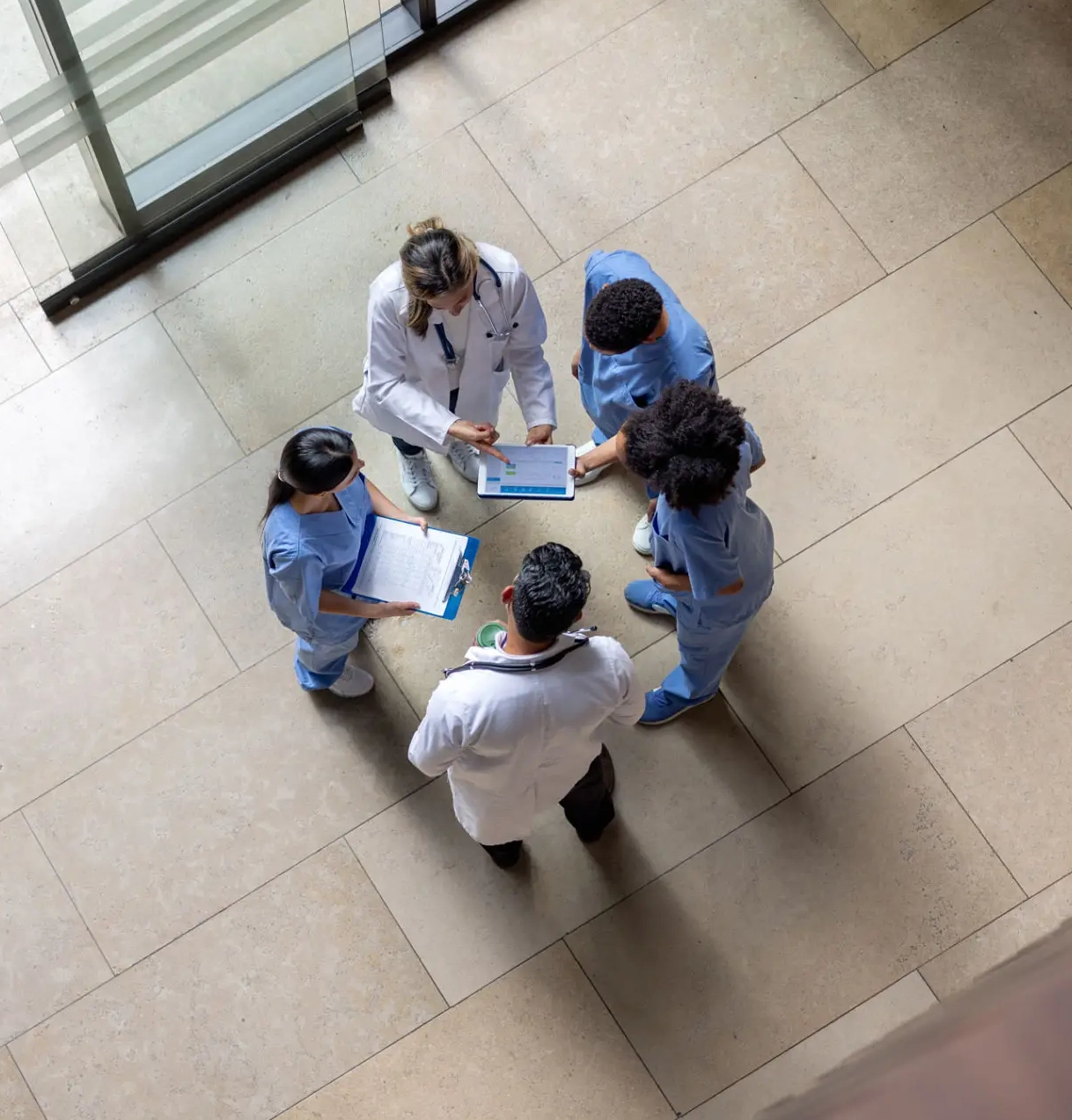 Medical team discussing patient charts in hallway